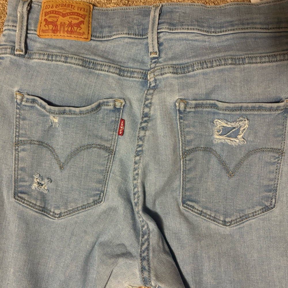 Lev’s 729 High Waisted Super Skinny Light Blue Distressed Denim Jeans